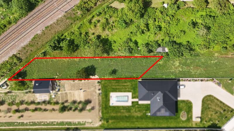 Land near the railway suitable for living in Nové Mesto nad Váhom, surrounded by greenery.