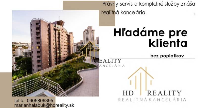 A building surrounded by greenery, next to modern residential blocks in Banská Bystrica.