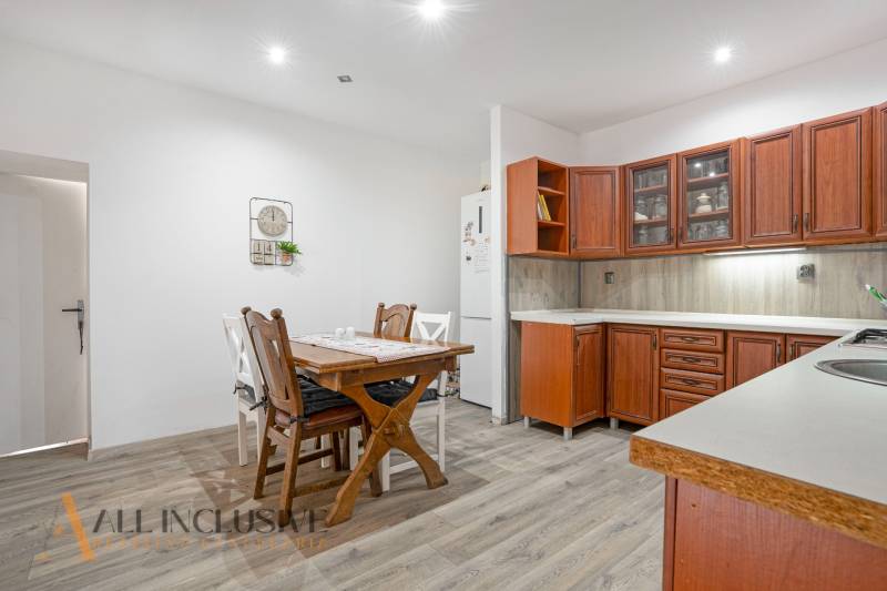 Kitchen with a table and wooden cabinets in a family house.