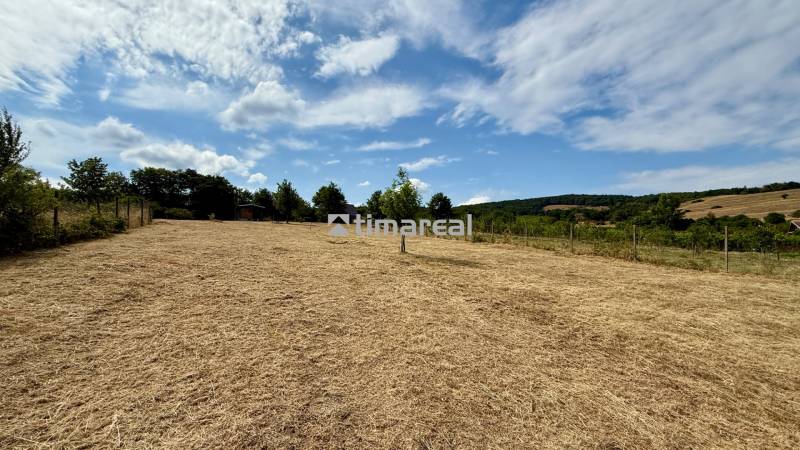A field in Limbach on Sadova Street with a beautiful view of the countryside and the sky.