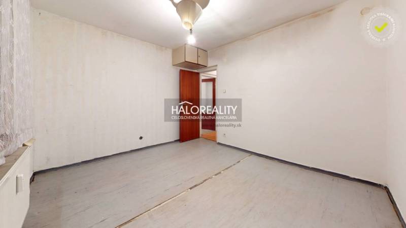 A view of an empty room with doors in a 3-room apartment, ready for renovation.