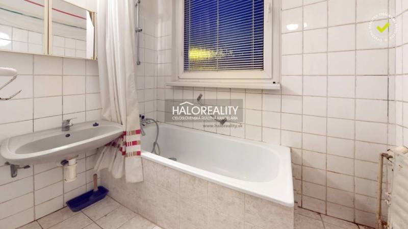 A bathroom with a bathtub and a sink, suitable for a 3-room apartment.
