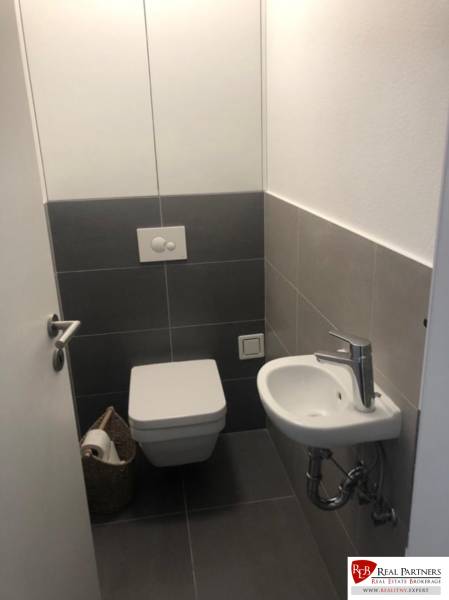 Bathroom with toilet and sink in a 2-room apartment.