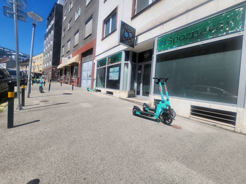 Electric scooters on Vysoká Street in the Old Town, Bratislava in front of commercial premises.