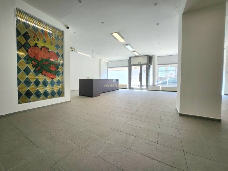 Commercial space with a colorful wall and reception, bright and spacious.