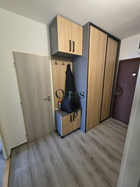 Entrance hall of a 2-room apartment with wooden furniture and practical storage space.