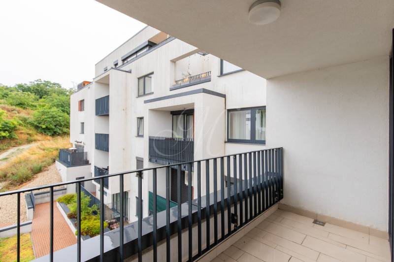 Balcony of an apartment building on Svätovavrinecká Street in Bratislava - Nové Mesto, natural surroundings.