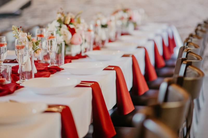 The tables in the dining area are elegantly set with white tablecloths and flowers.