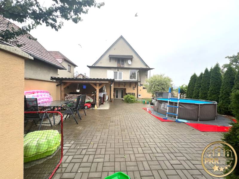 A family house in Veľké Chlievany with a garden, swimming pool, and a terrace with outdoor seating.