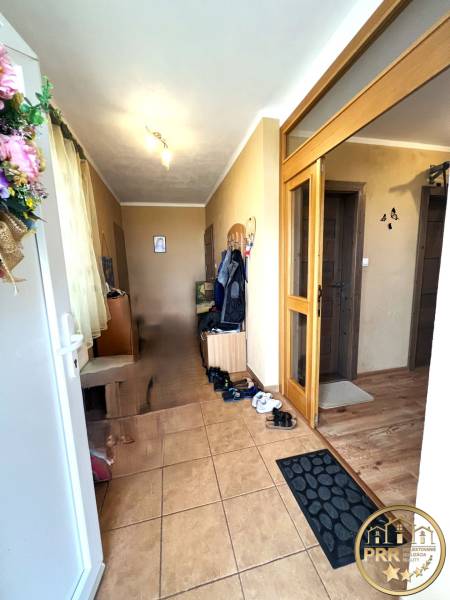 Entrance hallway in a family house with tiles and wooden doors.