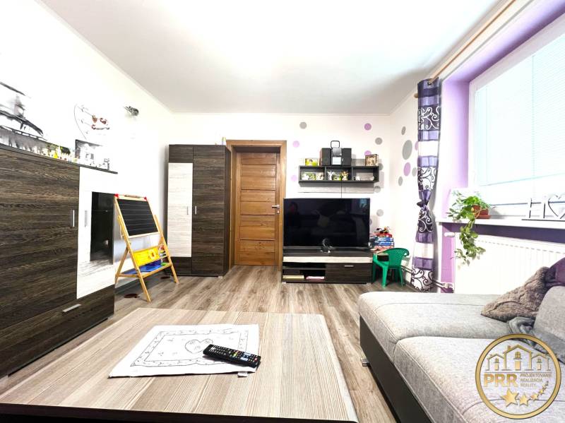 Living room in a family house with wooden furniture and decorations on the shelves.
