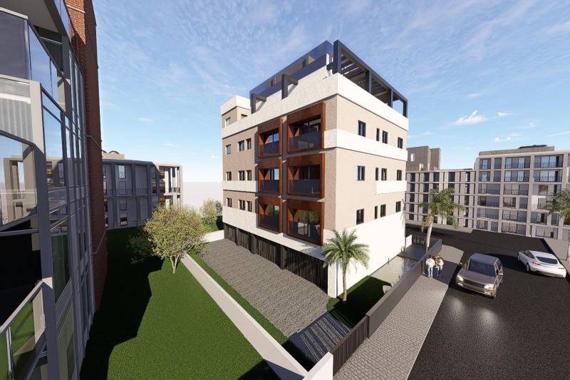 Residential complex in San Pedro del Pinatar with palm trees and parking in front of 3-bedroom apartments.