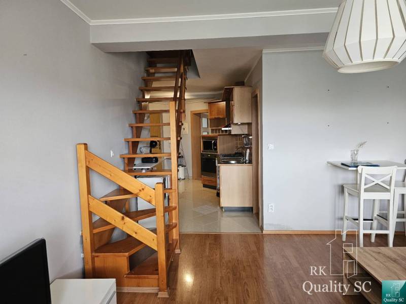 3-room apartment with wooden stairs, kitchen, and dining area.