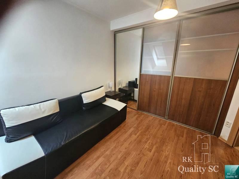 Living room with a sofa and a built-in wardrobe in a 3-room apartment.