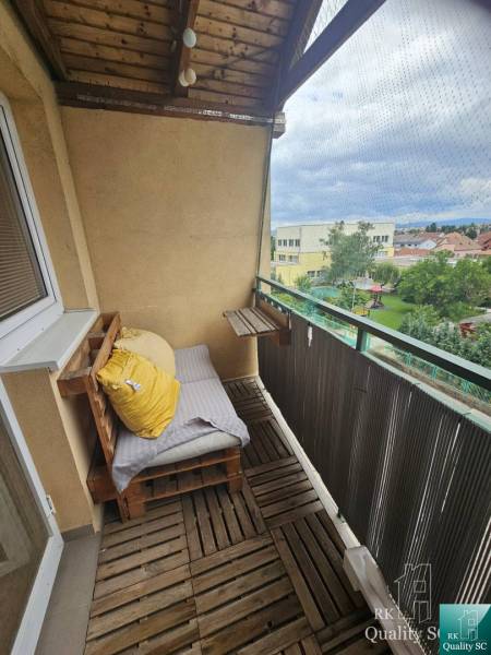 Balcony with wooden flooring and railing in a 3-room apartment on Kysucká Street in Senec.