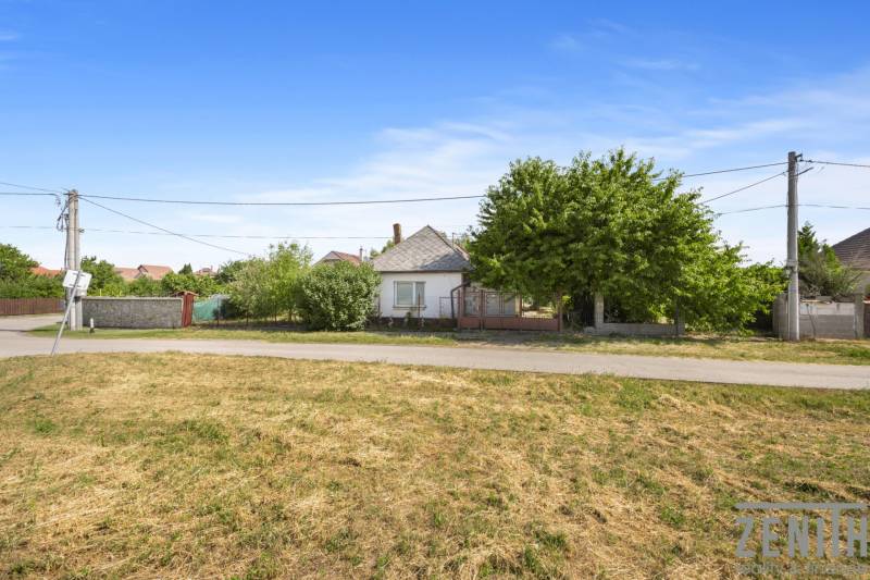 A house in Dobrohošť surrounded by greenery, suitable for residential plots.