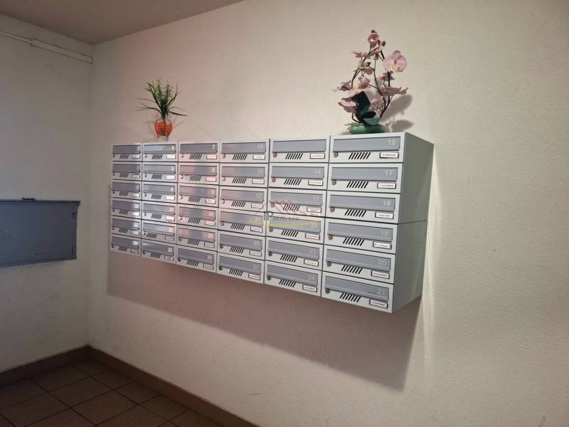 Mailboxes in a 3-room apartment decorated with flowers, creating a pleasant entrance area.