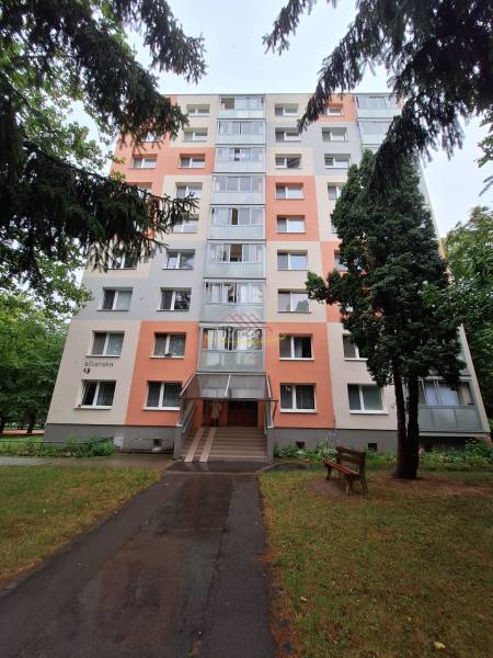 An apartment building on Trenčianska Street in Nová Dubnica surrounded by greenery.