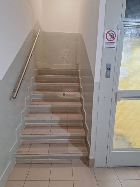 Entrance to an apartment building with an elevator and staircase suitable for a 3-bedroom apartment.