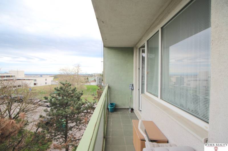 A balcony on a 3-room apartment with a view of greenery in Bratislava on Na Revíne street.