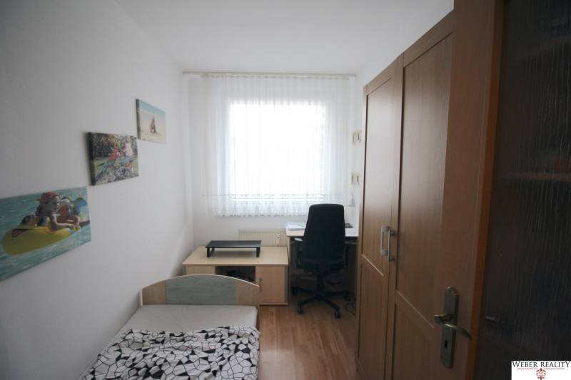 A room with a bed, a desk, and a wardrobe in a 3-room apartment.