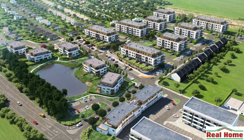 Aerial view of a residential complex, parking lot, and pond, suitable for a 3-room apartment.