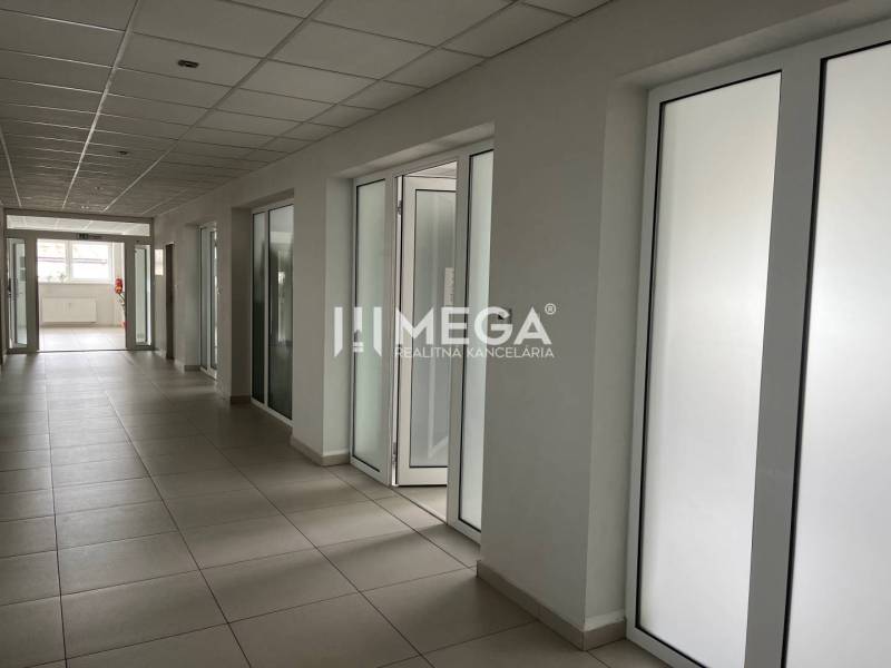 Offices with a corridor and doors, featuring a suspended ceiling and tiles.
