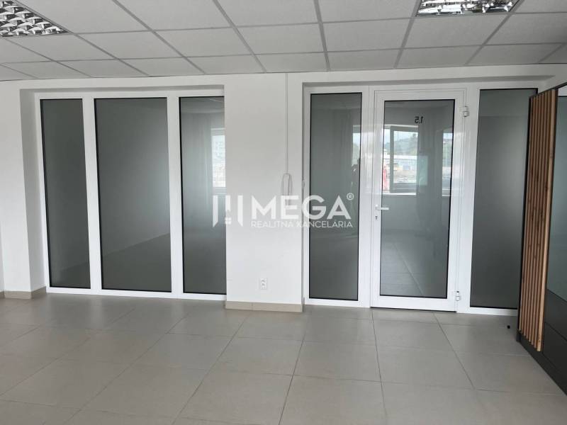 Spacious office with glass doors and white walls.