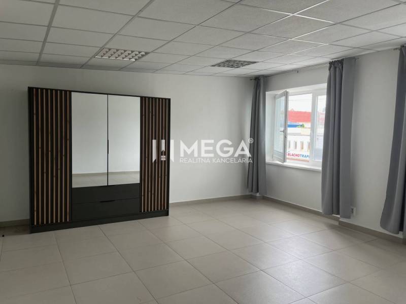 Interior of an office with a window, curtains, and a cabinet on Tolstého Street in Humenné.