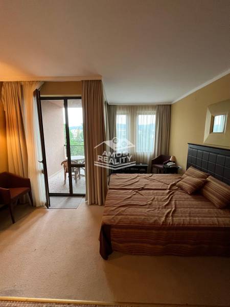 A bedroom in a holiday apartment with a large bed and a balcony, ideal for relaxation.