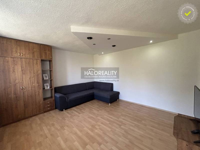 Living room with a wooden cabinet, sofa in a studio apartment, pleasant atmosphere.