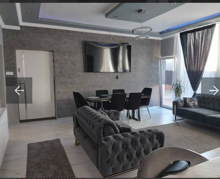 An elegant living space in a family house with comfortable sofas and a television.