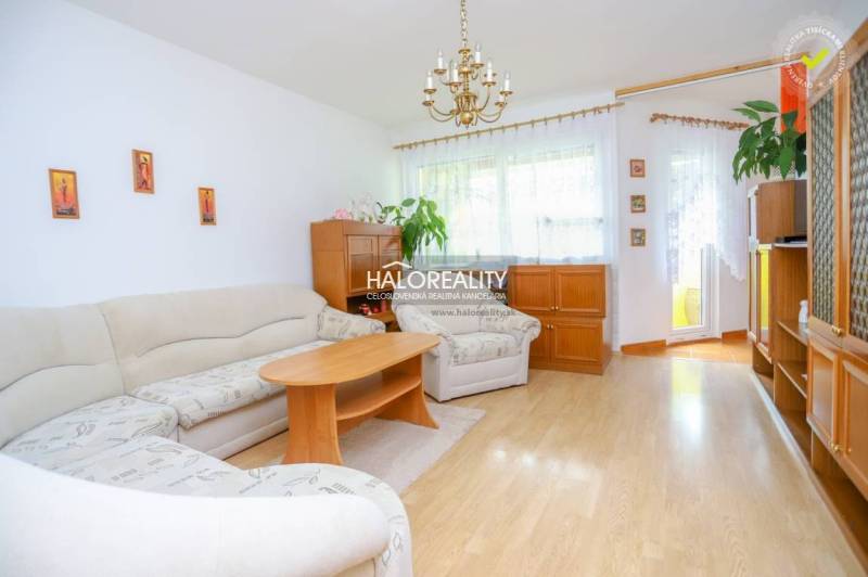 Living room with a large sofa, table, and wooden furniture in a 3-room apartment.