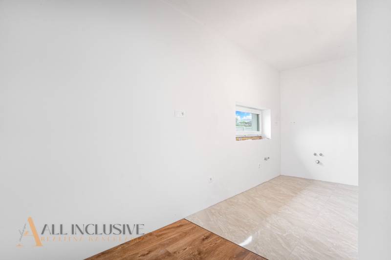Cozy room with white walls and a small window in a family house.