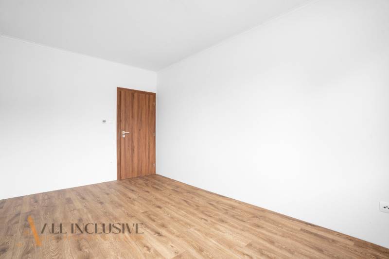 A room in a family house with wooden doors and floor.