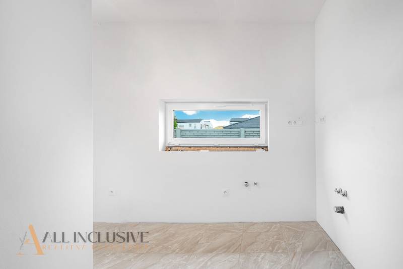 White wall with a window and tiles in a family house.