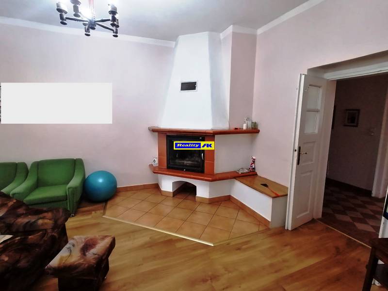 Living room in a family house with a fireplace, sofa, and exercise ball.