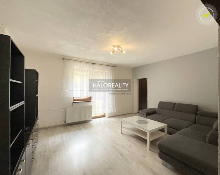 Living room in a family house with a sofa, coffee table, and shelving unit.