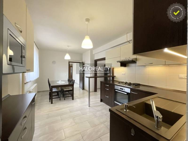 Kitchen with a dining table and modern equipment in a family house.
