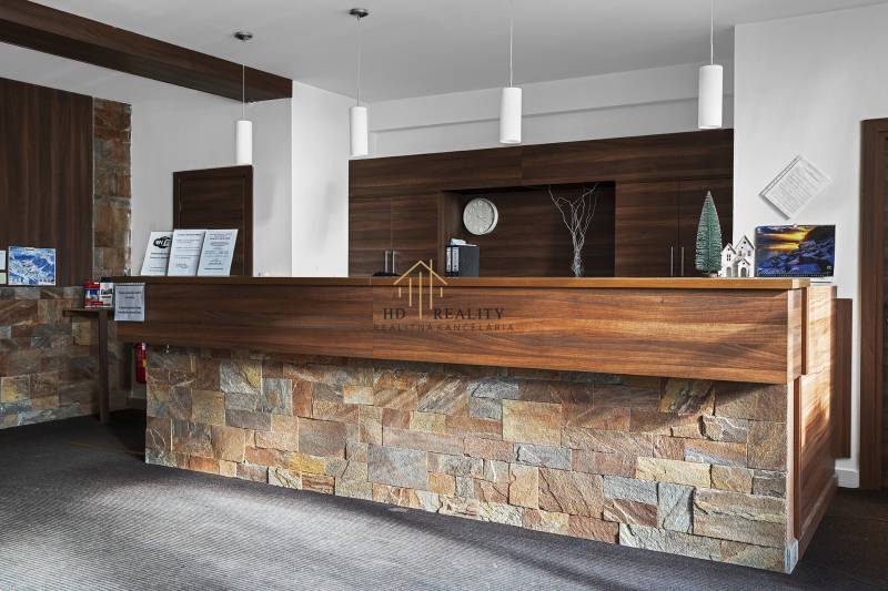 Reception in the entrance hall with a wooden counter and paneling in a 2-room apartment.