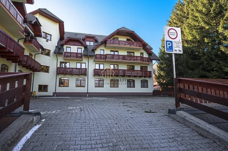 Apartment building with parking and balconies on the street in Donovaly.