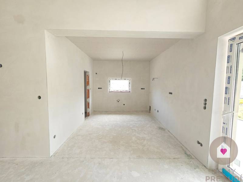 Interior of a family house with unfinished walls and floor, ready for completion.