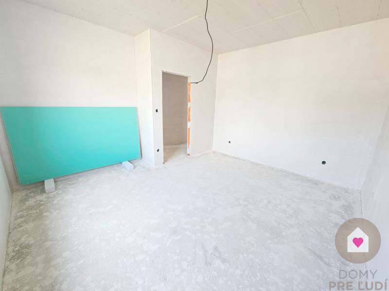 Empty room in a family house with white walls and a green board.