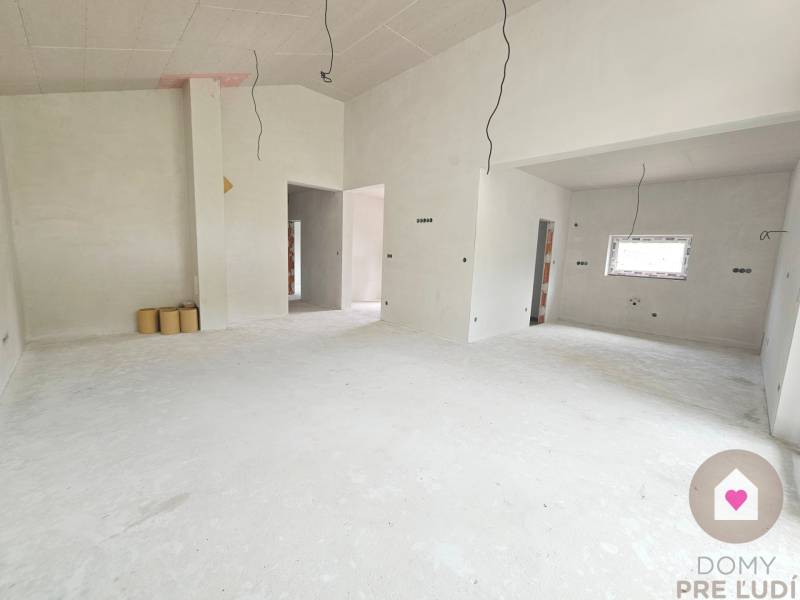 The interior of a family house with unfinished walls and a window, ready for completion.