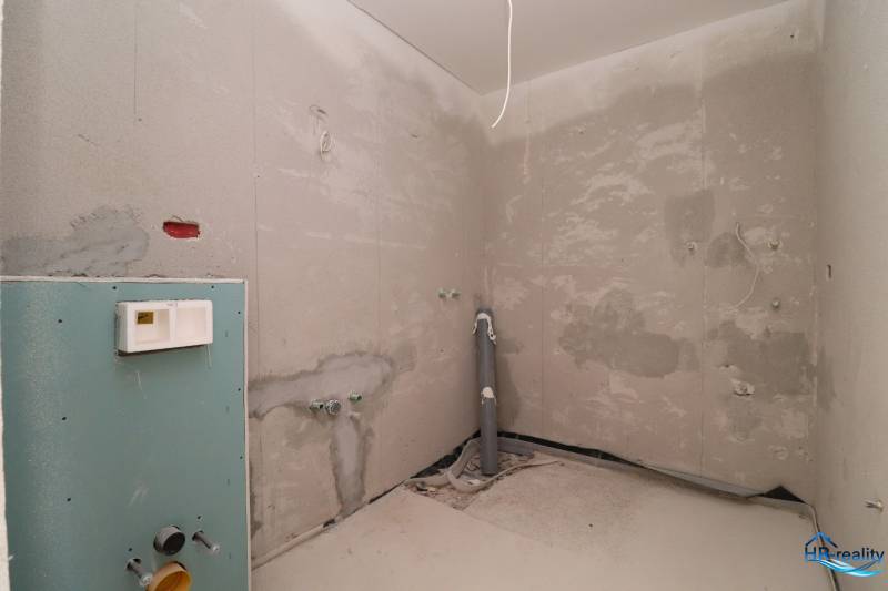 The stage of bathroom reconstruction in the Recreational Apartment with visible installation elements.