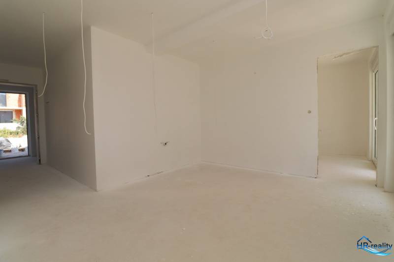 A bright room in a holiday apartment with white walls and ongoing installation.