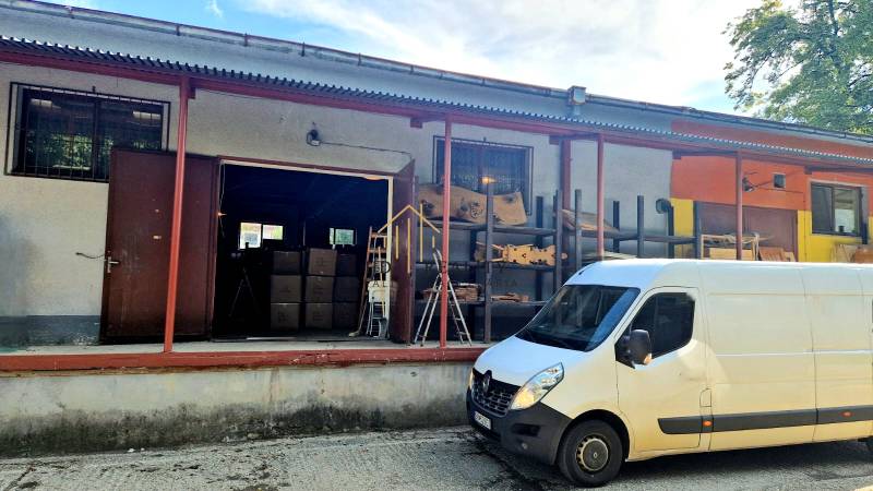 A building of warehouses and halls in Banská Bystrica with a white van in front of the entrance.