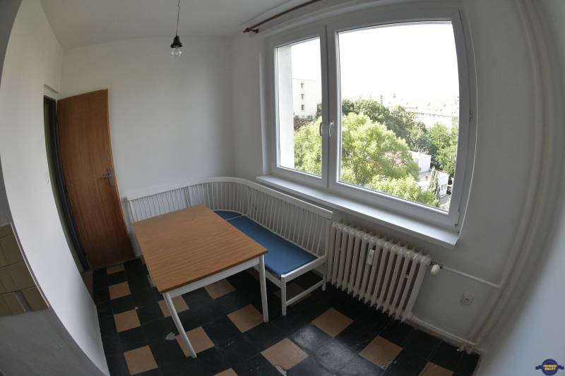 Dining room with a corner bench and a view in a 2-room apartment.