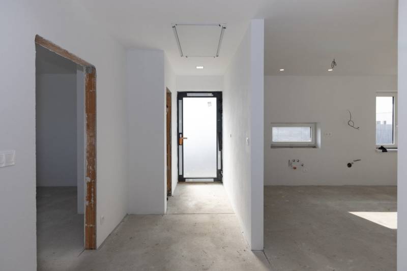 Empty hallway in a family house with white walls and open space.