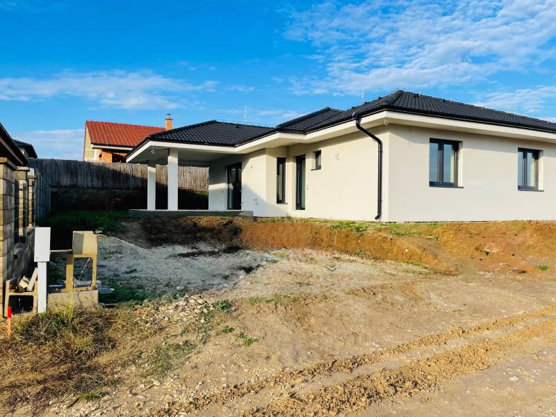 A newly built family house in Kynek, Nitra with simple architecture and a white facade.